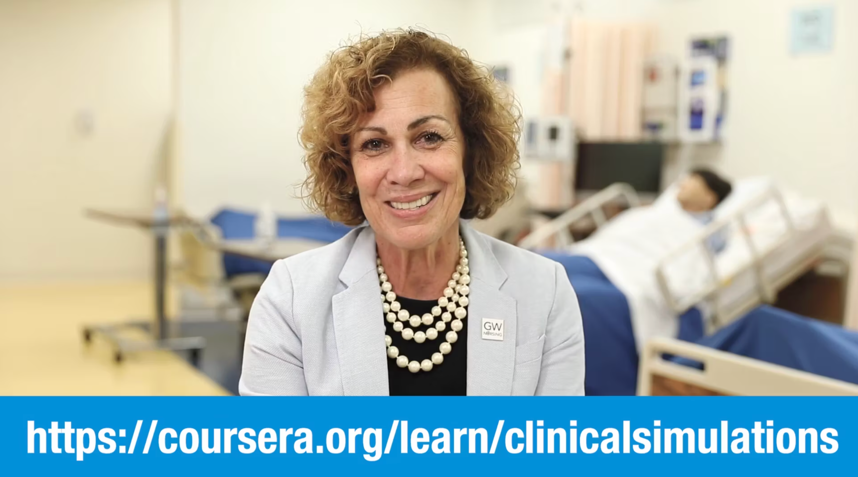 Clinical Simulation MOOC course image showing instructor speaking in a healthcare simulation lab with hospital bed and mannequin in background